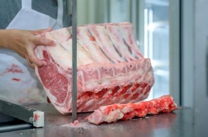 stock-photo-close-up-of-raw-meat-cutting-with-a-saw-or-bone-cutter-in-an-abattoir-where-wagyu-is-cut-and-2103567401(1).jpg